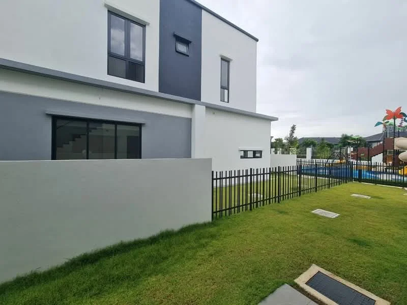 Exterior type: detached bungalow; features: white painted facade, grey accent wall, manicured lawn, fenced yard, playground visible in background, paved walkway, two-storey structure, large windows; style: modern.